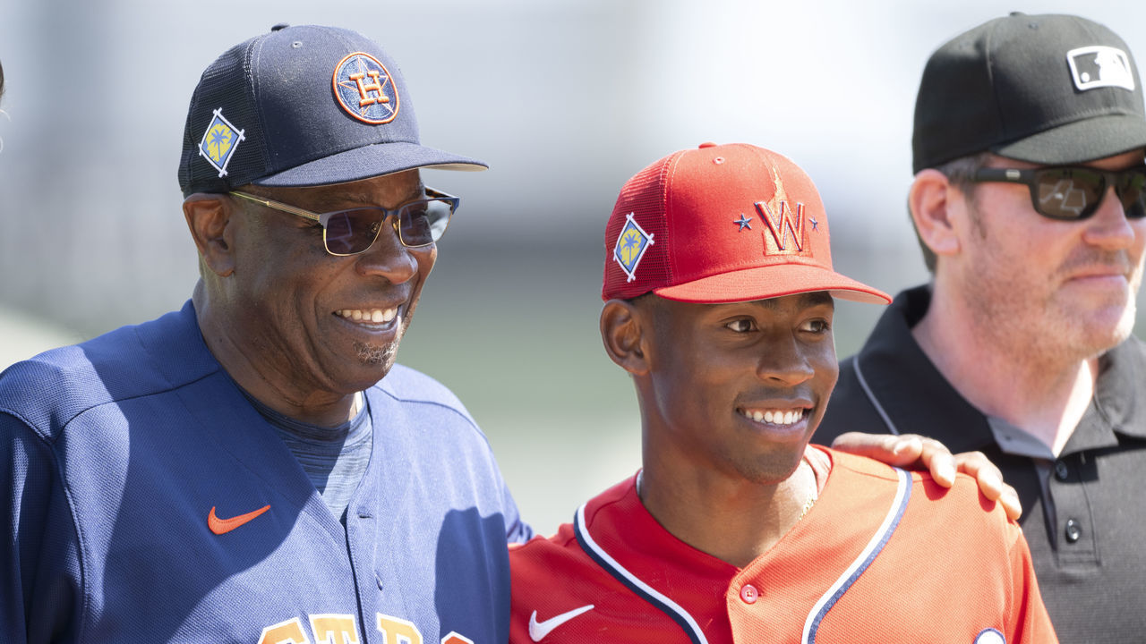 WEST PALM BEACH, FL - MARCH 20: Houston Astros manager Dusty Baker poses with his son, Washington Nationals minor league player Darren Baker after exchanging lineups before an MLB spring training game between the Washington Nationals and the Houston Astros at The Ballpark of The Palm Beaches on March 19, 2022 in West Palm Beach, Florida.