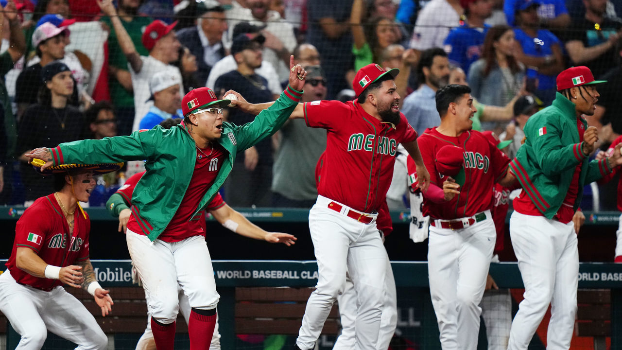 PHOENIX, AZ - MARCH 17: Julio Urías #7 and José Urquidy #59 of Team Mexico celebrate after a two-run single by Isaac Paredes #17 ties the game in the seventh inning during the 2023 World Baseball Classic Quarterfinal game between Team Puerto Rico and Team Mexico at loanDepot Park on Friday, March 17, 2023 in Miami, Florida.