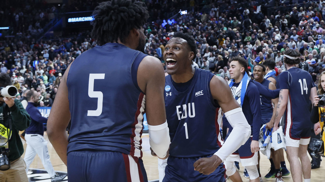 COLUMBUS, OH - MARCH 17: Ansley Almonor #5 and Joe Munden #1 of the Fairleigh Dickinson Knights celebrate their win over the Purdue Boilermakers in the first round of the 2022 NCAA Men's Basketball Tournament held at Nationwide Arena on March 17, 2023 in Columbus, Ohio.