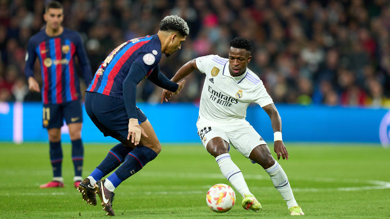 MADRID, SPAIN - MARCH 02: Vinicius Junior of Real Madrid is challenged by Ronald Araujo of FC Barcelona during the Copa del Rey Semi Final first leg match between Real Madrid and FC Barcelona at Estadio Santiago Bernabeu on March 02, 2023 in Madrid, Spain.