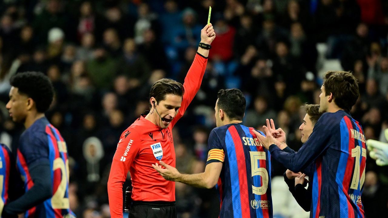 Barcelona's Spanish midfielder Gavi (2nd-R) reacts with teammates after receiving a yellow card from Spanish referee Jose Luis Munuera Montero (C) during the Copa del Rey (King's Cup) semi final first leg football match between Real Madrid CF and FC Barcelona at the Santiago Bernabeu stadium in Madrid on March 2, 2023.