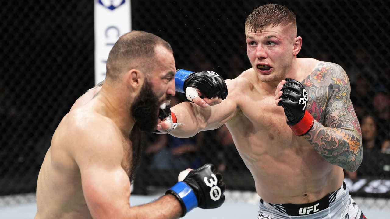 LONDON, ENGLAND - MARCH 18: (R-L) Marvin Vettori of Italy punches Roman Dolidze of Georgia in a middleweight fight during the UFC 286 event at The O2 Arena on March 18, 2023 in London, England.