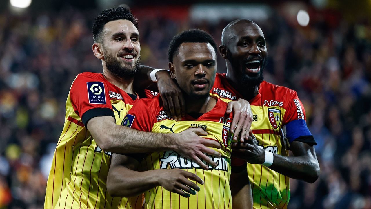 Lens' Belgian forward Lois Openda (C) celebrates his second goal next to his teammates Lens' French forward Adrien Thomasson (L) and Lens' Franco-Ivorian midfielder Seko Fofana (R) during the French L1 football match between RC Lens and SCO Angers at Stade Bollaert-Delelis in Lens, northern France on March 18, 2023.