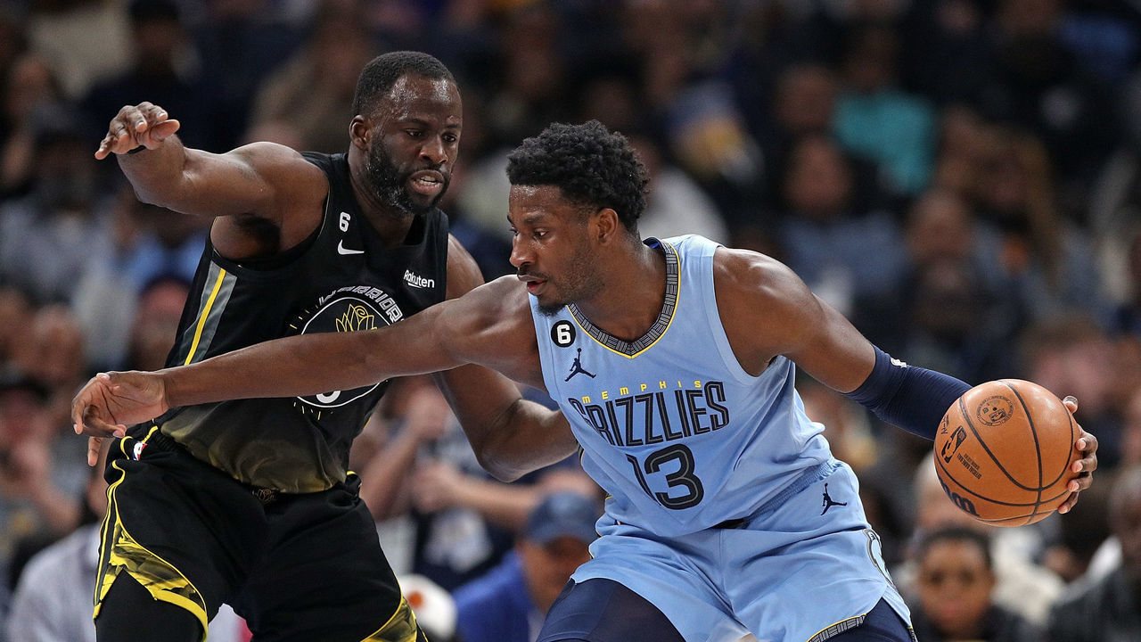 MEMPHIS, TENNESSEE - MARCH 18: Jaren Jackson Jr. #13 of the Memphis Grizzlies handles the ball against Draymond Green #23 of the Golden State Warriors during the first half of the game at FedExForum on March 18, 2023 in Memphis, Tennessee.