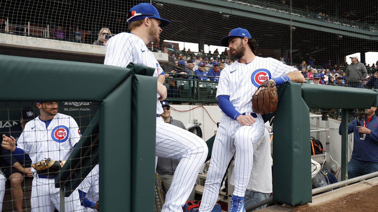 MESA, ARIZONA - MARCH 01: Ian Happ #8 (L) and Dansby Swanson #7 of the Chicago Cubs wait to take the field for the spring training game against the Seattle Mariners at Sloan Park on March 01, 2023 in Mesa, Arizona.