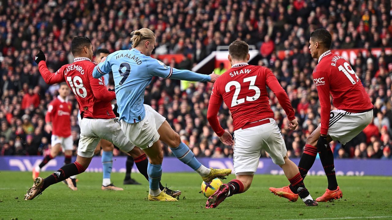 Manchester United's Brazilian midfielder Casemiro challenges Manchester City's Norwegian striker Erling Haaland during the English Premier League football match between Manchester United and Manchester City at Old Trafford in Manchester, north west England, on January 14, 2023. - RESTRICTED TO EDITORIAL USE. No use with unauthorized audio, video, data, fixture lists, club/league logos or 'live' services. Online in-match use limited to 120 images. An additional 40 images may be used in extra time. No video emulation. Social media in-match use limited to 120 images. An additional 40 images may be used in extra time. No use in betting publications, games or single club/league/player publications.