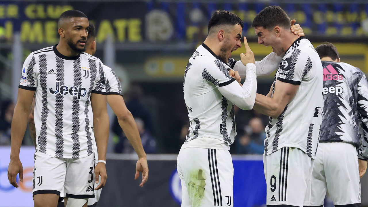 MILAN, ITALY - MARCH 19: Filip Kostic of Juventus celebrates with Dusan Vlahovic after scoring the opening goal during the Serie A match between FC Internazionale and Juventus at Stadio Giuseppe Meazza on March 19, 2023 in Milan, Italy.