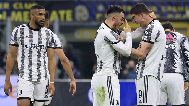 MILAN, ITALY - MARCH 19: Filip Kostic of Juventus celebrates with Dusan Vlahovic after scoring the opening goal during the Serie A match between FC Internazionale and Juventus at Stadio Giuseppe Meazza on March 19, 2023 in Milan, Italy.