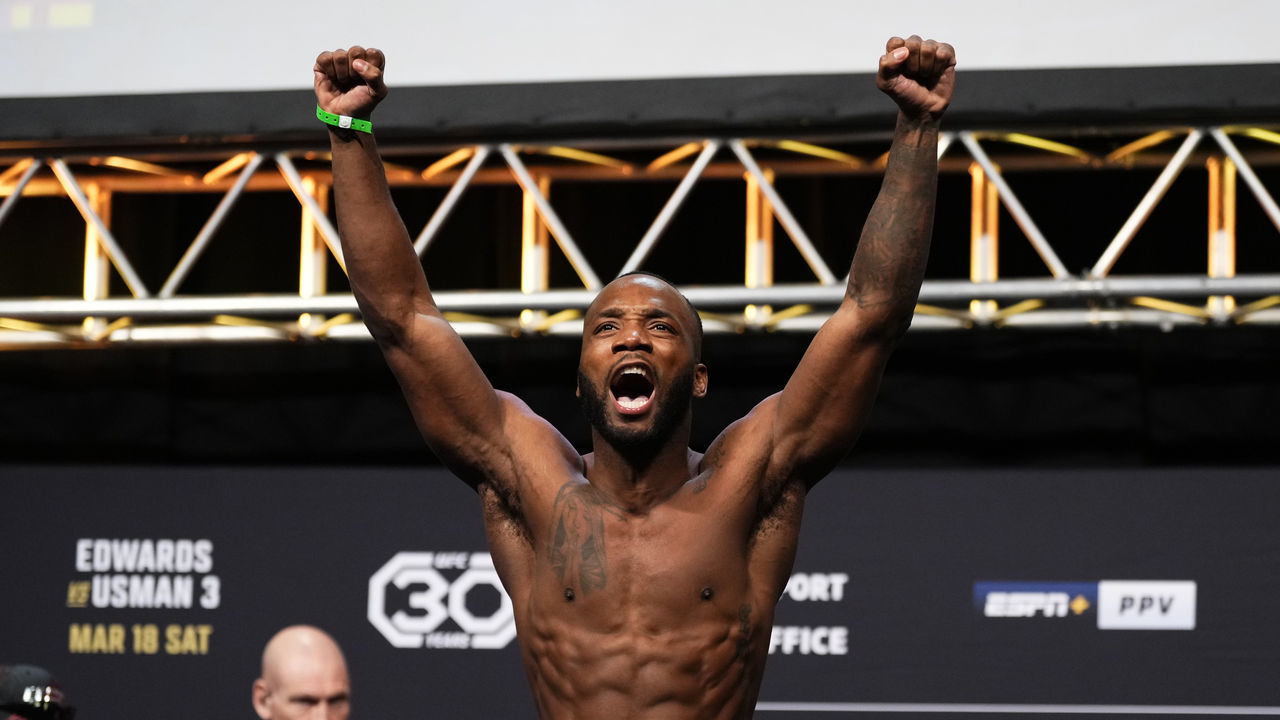 LONDON, ENGLAND - MARCH 17: Leon Edwards of Jamaica poses on the scale during the UFC 286 ceremonial weigh-in at The O2 Arena on March 17, 2023 in London, England.