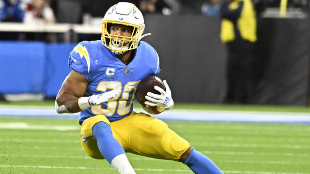Inglewood, CA - December 11: running back Austin Ekeler #30 of the Los Angeles Chargers runs for first down against the Miami Dolphins in the first half of a NFL football game at SoFi Stadium in Inglewood on Sunday, December 11, 2022.