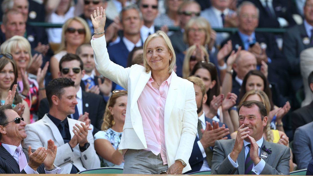 Czech-born US former tennis champion Martina Navratilova stands and waves in the royal box on centre court before the start of the men's singles third round match between Australia's Samuel Groth and Switzerland's Roger Federer on day six of the 2015 Wimbledon Championships at The All England Tennis Club in Wimbledon, southwest London, on July 4, 2015. RESTRICTED TO EDITORIAL USE -- AFP PHOTO / JUSTIN TALLIS