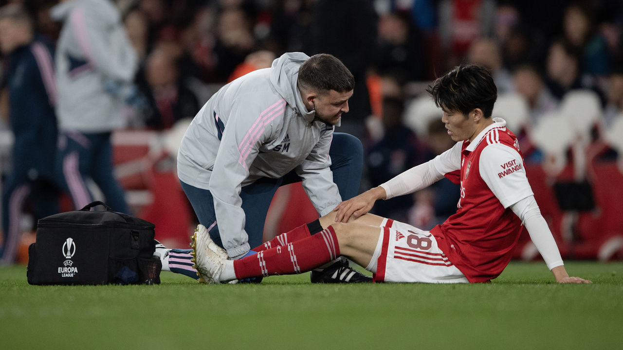 LONDON, ENGLAND - MARCH 16: Takehiro Tomiyasu receives attention from Arsenal medical staff before being substituted during the UEFA Europa League round of 16 leg two match between Arsenal FC and Sporting CP at Emirates Stadium on March 16, 2023 in London, England.