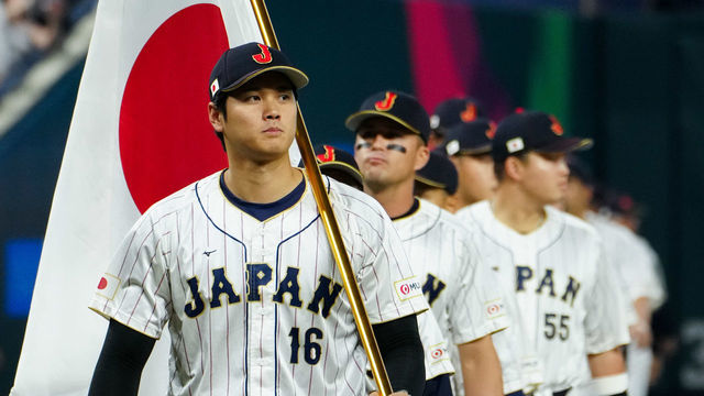 MIAMI, FL - MARCH 21: Shohei Ohtani #16 of Team Japan carries a Japanese flag while leading the team onto the field prior to the 2023 World Baseball Classic Championship game between Team USA and Team Japan at loanDepot Park on Tuesday, March 21, 2023 in Miami, Florida.