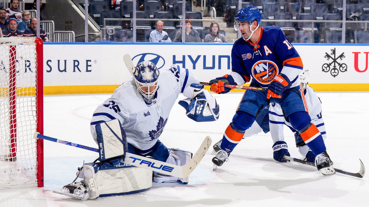 ELMONT, NEW YORK - MARCH 21: Ilya Samsonov #35 of the Toronto Maple Leafs makes the save against Cal Clutterbuck #15 of the New York Islanders during the third period at UBS Arena on March 21, 2023 in Elmont, New York.