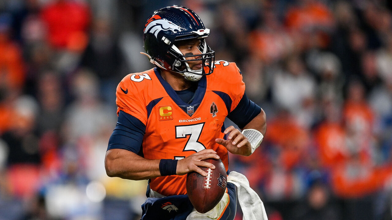 DENVER, CO - JANUARY 8: Denver Broncos quarterback Russell Wilson (3) rolls out of the pocket during a game between the Los Angeles Chargers and the Denver Broncos at Empower Field at Mile High on January 8, 2023 in Denver, Colorado.