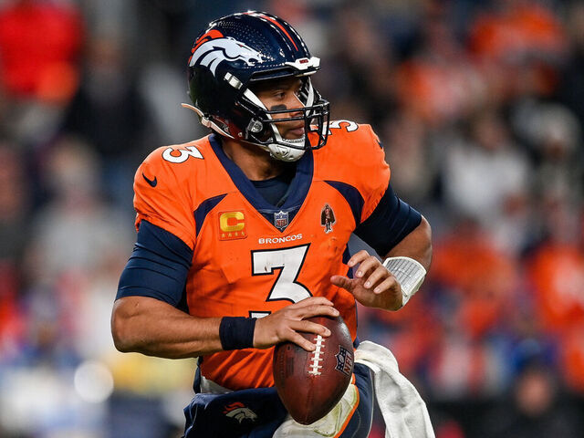 DENVER, CO - JANUARY 8: Denver Broncos quarterback Russell Wilson (3) rolls out of the pocket during a game between the Los Angeles Chargers and the Denver Broncos at Empower Field at Mile High on January 8, 2023 in Denver, Colorado.