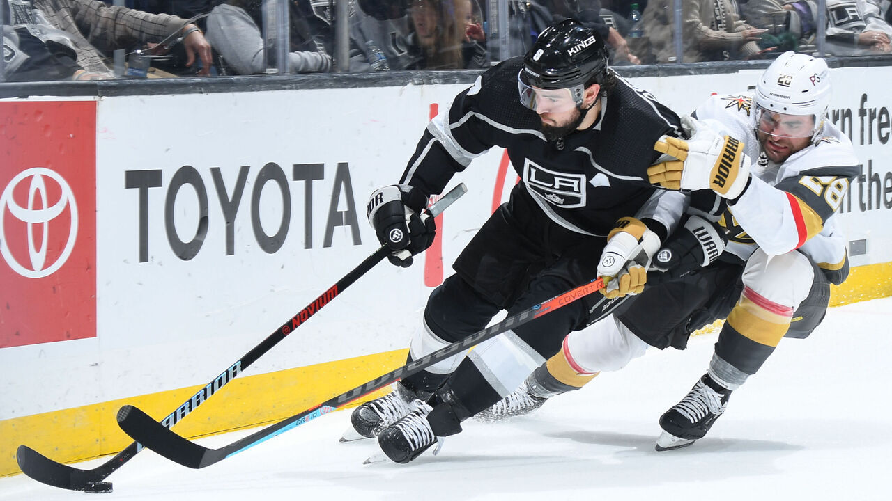 LOS ANGELES, CA - DECEMBER 27: Drew Doughty #8 of the Los Angeles Kings and William Carrier #28 of the Vegas Golden Knights battle for the puck during the second period at Crypto.com Arena on December 27, 2022 in Los Angeles, California.