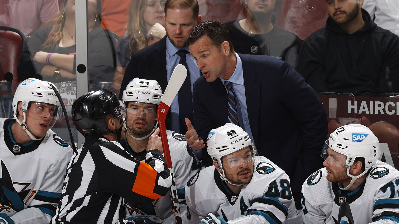 SUNRISE, FL - FEBRUARY 9: Referee Chris Rooney #5 talks to head coach David Quinn of the San Jose Sharks during a break in action against the Florida Panthers in the third period at FLA Live Arena on February 9, 2023 in Sunrise, Florida.
