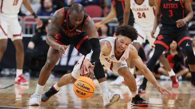 LOUISVILLE, KENTUCKY - MARCH 24: Mark Sears #1 of the Alabama Crimson Tide and Adam Seiko #2 of the San Diego State Aztecs fight for the ball during the second half in the Sweet 16 round of the NCAA Men's Basketball Tournament at KFC YUM! Center on March 24, 2023 in Louisville, Kentucky.