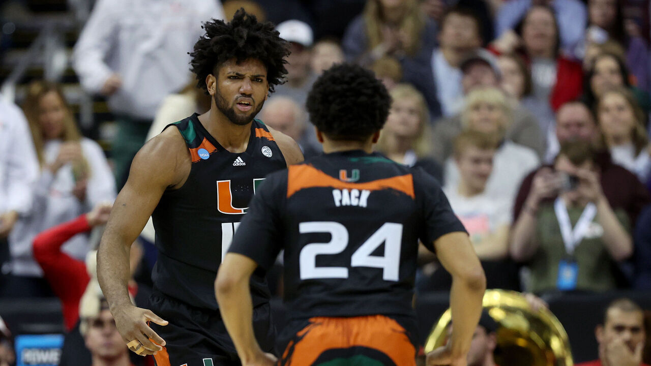 KANSAS CITY, MISSOURI - MARCH 24: Norchad Omier #15 of the Miami Hurricanes reacts after scoring with teammate Nijel Pack #24 during the first half against the Houston Cougars in the Sweet 16 round of the NCAA Men's Basketball Tournament at T-Mobile Center on March 24, 2023 in Kansas City, Missouri.