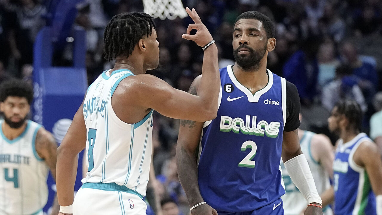 DALLAS, TEXAS - MARCH 24: Dennis Smith Jr. #8 of the Charlotte Hornets celebrates in front of Kyrie Irving #2 of the Dallas Mavericks after scoring a three-point basket late in the second half at American Airlines Center on March 24, 2023 in Dallas, Texas. NOTE TO USER: User expressly acknowledges and agrees that, by downloading and/or using this Photograph, user is consenting to the terms and conditions of the Getty Images License Agreement.