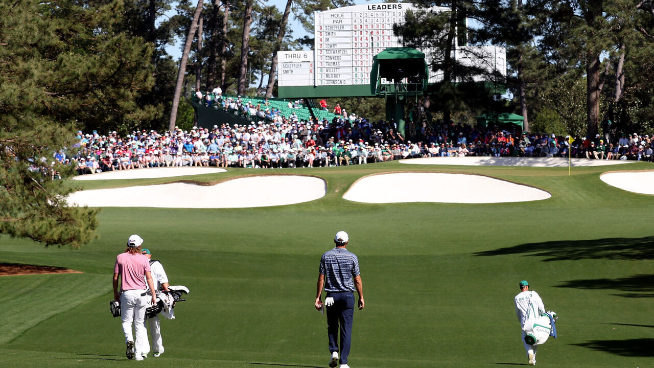 AUGUSTA, GEORGIA - APRIL 10: The group of Cameron Smith of Australia and Scottie Scheffler walks across the seventh hole during the final round of the Masters at Augusta National Golf Club on April 10, 2022 in Augusta, Georgia.