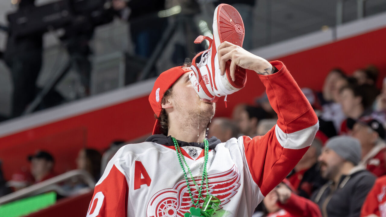 DETROIT, MI - MARCH 18: A Detroit Red Wings fan chugs a beer out of his sneaker during the third period of an NHL game against the Colorado Avalanche at Little Caesars Arena on March 18, 2023 in Detroit, Michigan. Colorado defeated Detroit 5-1.