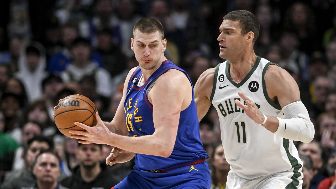 DENVER, CO - MARCH 25: Nikola Jokic (15) of the Denver Nuggets works against Brook Lopez (11) of the Milwaukee Bucks during the first quarter at Ball Arena in Denver on Saturday, March 25, 2023.