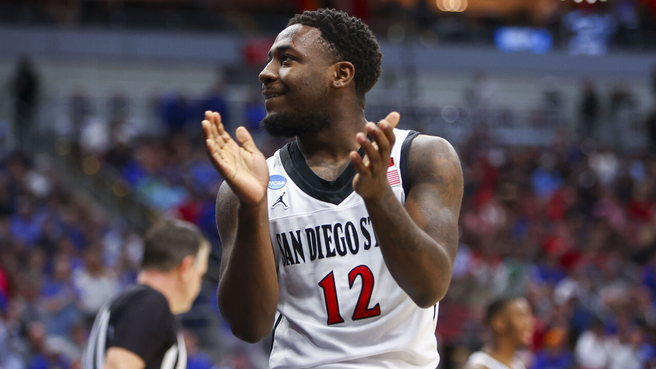 LOUISVILLE, KY - MARCH 26: Darrion Trammell #12 of the San Diego State Aztecs celebrates drawing a charge from the Creighton Bluejays during the Elite Eight round of the 2023 NCAA Men's Basketball Tournament held at KFC YUM! Center on March 26, 2023 in Louisville, Kentucky.