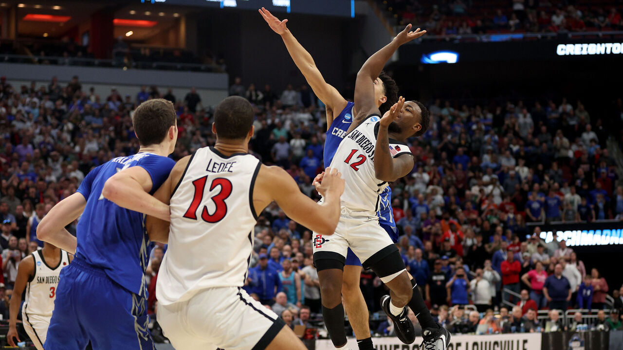 LOUISVILLE, KENTUCKY - MARCH 26: Ryan Nembhard #2 of the Creighton Bluejays fouls Darrion Trammell #12 of the San Diego State Aztecs during the second half in the Elite Eight round of the NCAA Men's Basketball Tournament at KFC YUM! Center on March 26, 2023 in Louisville, Kentucky.