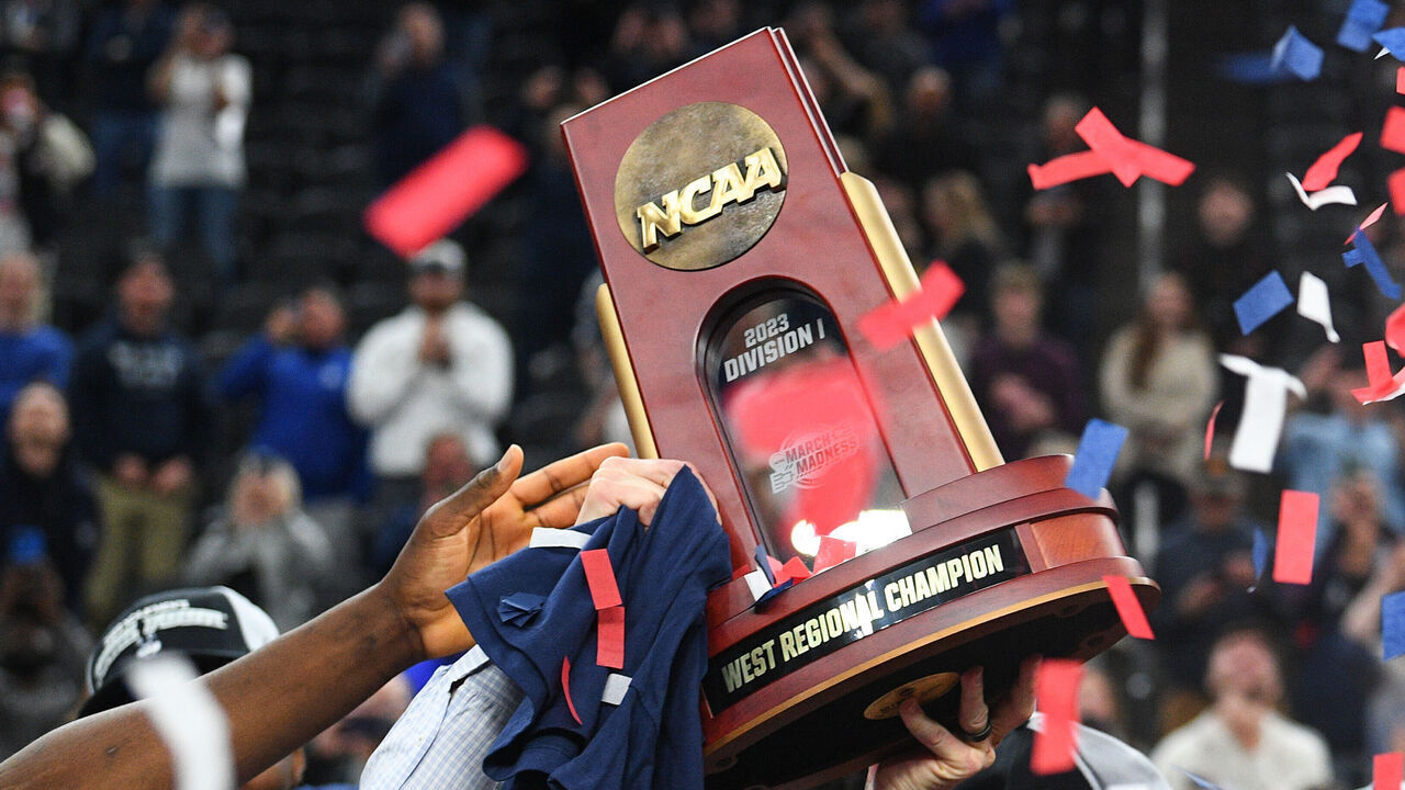 LAS VEGAS, NV - MARCH 25: UConn Huskies players hold up the trophy after advancing to the Final Four after winning the NCAA Division I Men's Championship Elite Eight round basketball game between the Gonzaga Bulldogs and the UConn Huskies on March 25, 2023 at T-Mobile Arena in Las Vegas, NV.