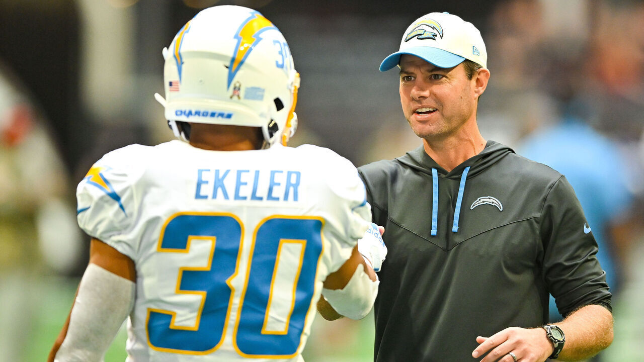 ATLANTA, GA NOVEMBER 06: Los Angeles head coach Brandon Staley greets running back Austin Ekeler (30) prior to the start of the NFL game between the Los Angeles Chargers and the Atlanta Falcons on November 6th, 2022 at Mercedes-Benz Stadium in Atlanta, GA.