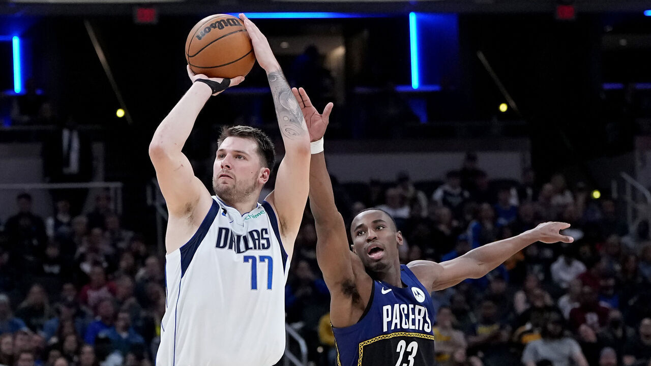 INDIANAPOLIS, INDIANA - MARCH 27: Luka Doncic #77 of the Dallas Mavericks attempts a shot while being guarded by Aaron Nesmith #23 of the Indiana Pacers in the third quarter at Gainbridge Fieldhouse on March 27, 2023 in Indianapolis, Indiana.