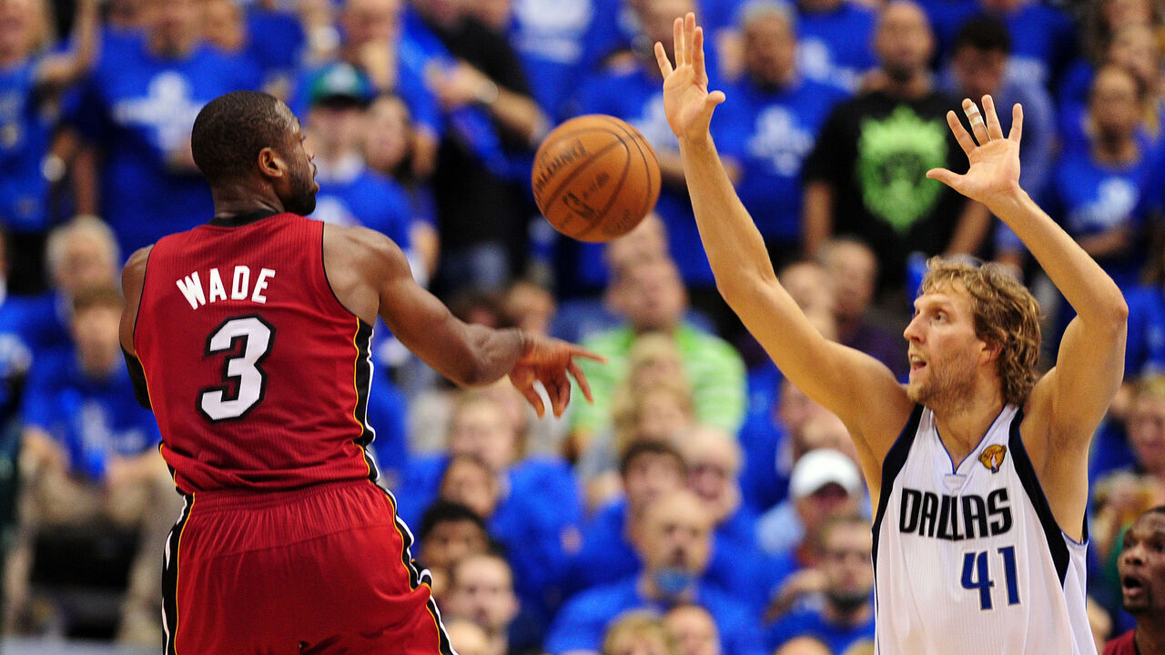Dwyane Wade (L) of the Miami Heat throws past Dirk Nowitzki of the Dallas Mavericksduring game 4 of the NBA Finals on June 7, 2011 at the American Airlines Center in Dallas, Texas. The Dallas Mavericks defeated the Miami Heat 86-83. AFP PHOTO / Robyn BECK AFP PHOTO / ROBYN BECK