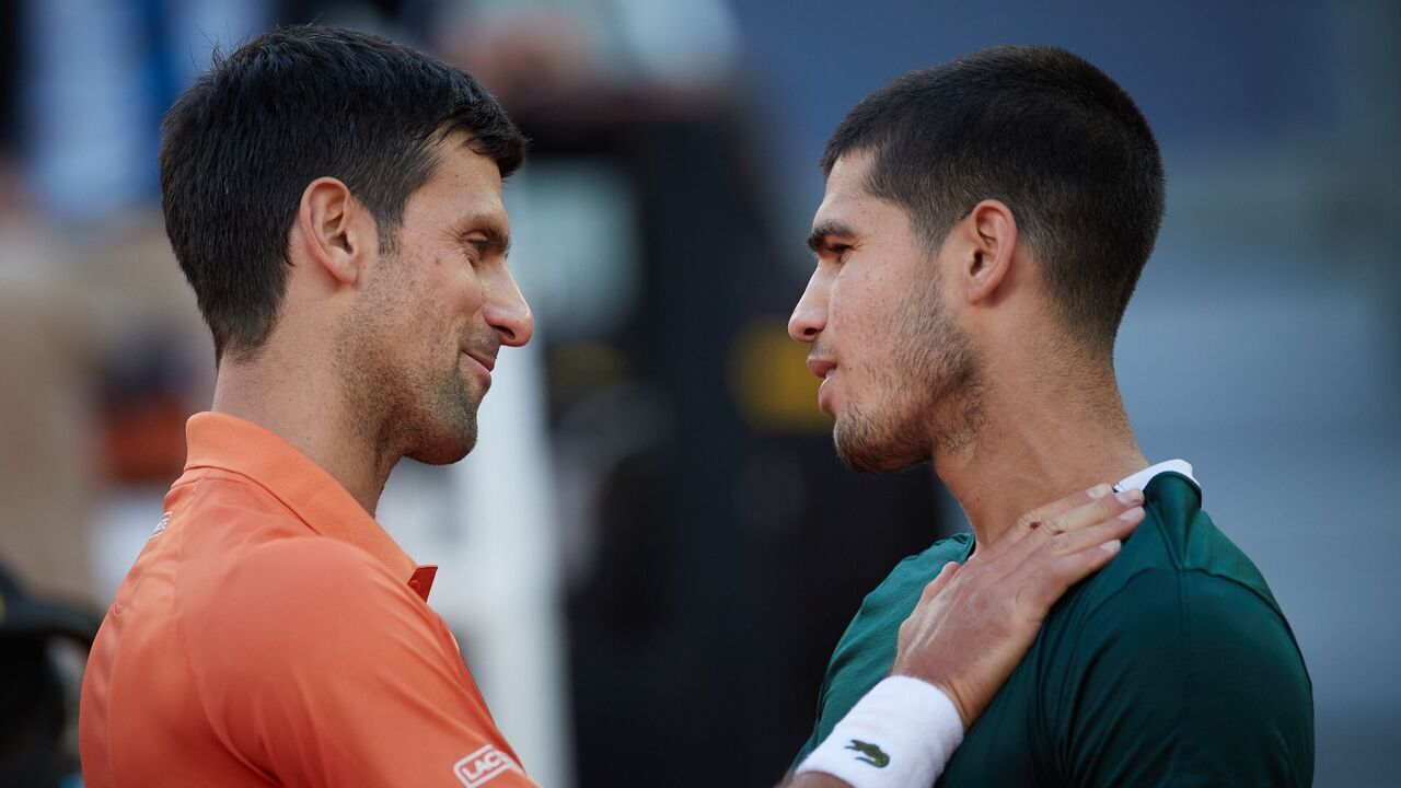 Novak Djokovic L of Serbia greets Carlos Alcaraz of Spain after their men's singles semifinal at the Madrid Open in Madrid, Spain, May 7, 2022.