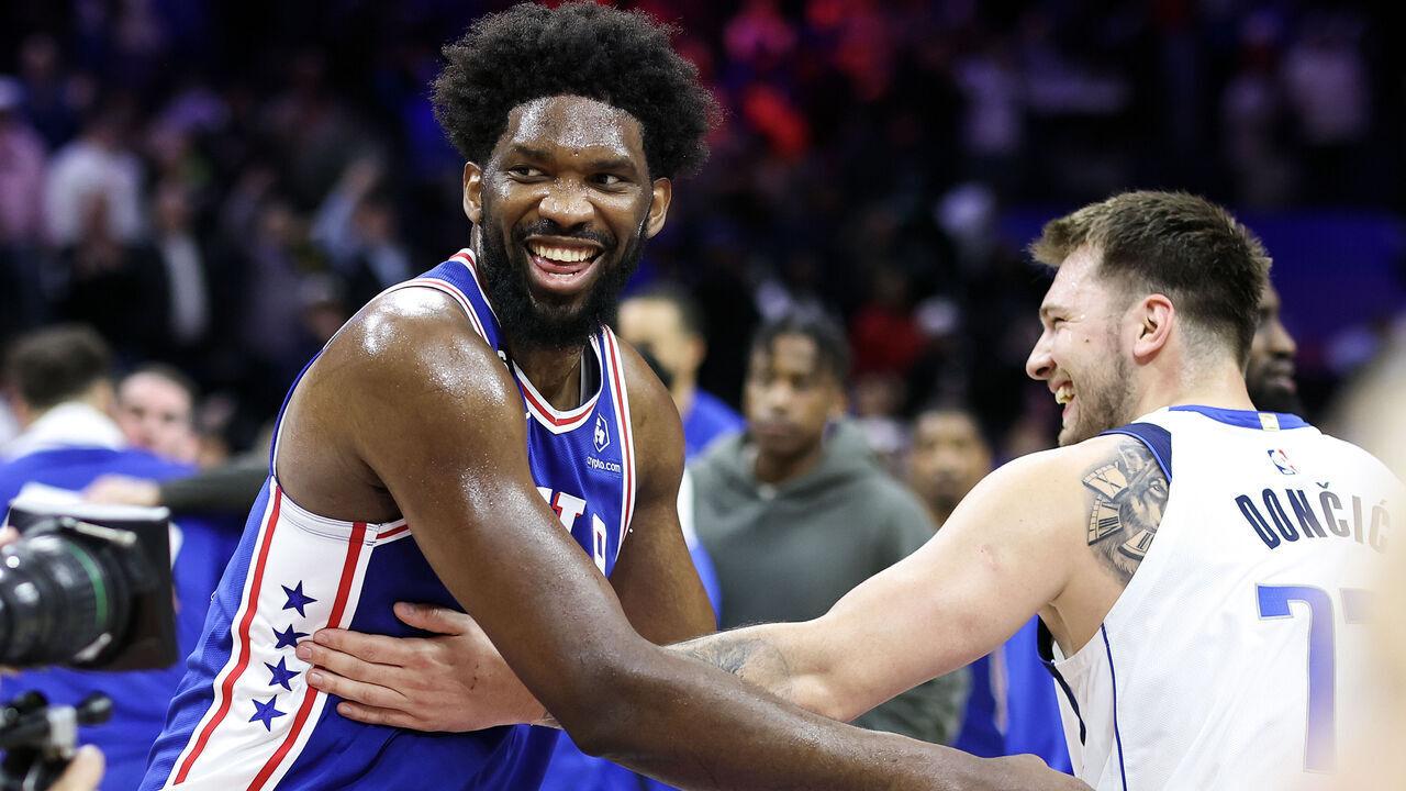 PHILADELPHIA, PENNSYLVANIA - MARCH 29: Joel Embiid #21 of the Philadelphia 76ers and Luka Doncic #77 of the Dallas Mavericks shake hands following a game at Wells Fargo Center on March 29, 2023 in Philadelphia, Pennsylvania.