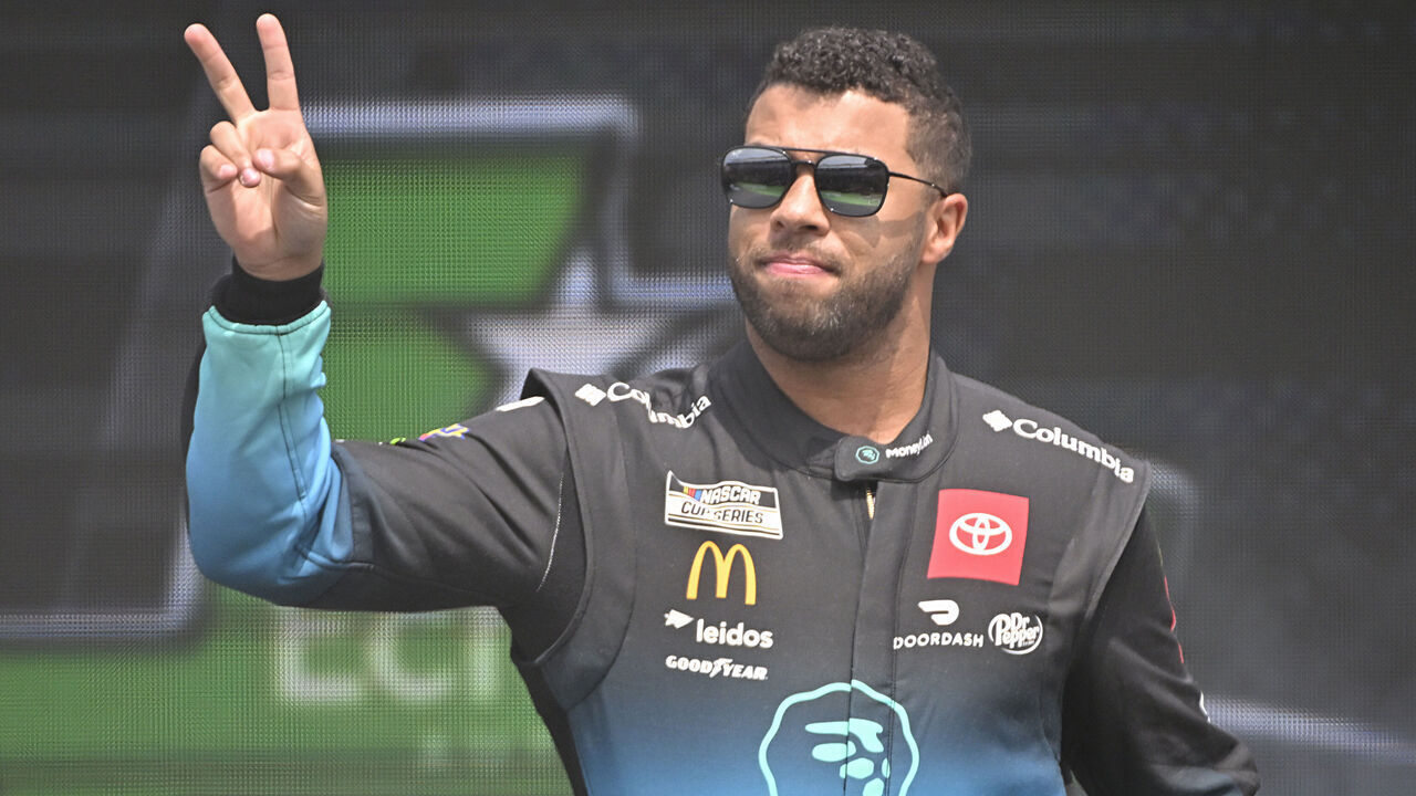 AUSTIN, TEXAS - MARCH 26: Bubba Wallace, driver of the #23 MoneyLion Toyota, waves to fans as he walks onstage during driver intros prior to the NASCAR Cup Series EchoPark Automotive Grand Prix at Circuit of The Americas on March 26, 2023 in Austin, Texas.