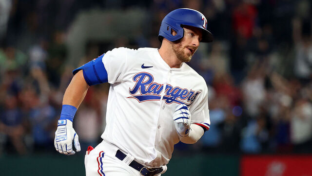 ARLINGTON, TEXAS - MARCH 30: Robbie Grossman #4 of the Texas Rangers runs the bases on his three-run home run against the Philadelphia Phillies in the fourth inning on Opening Day at Globe Life Field on March 30, 2023 in Arlington, Texas.