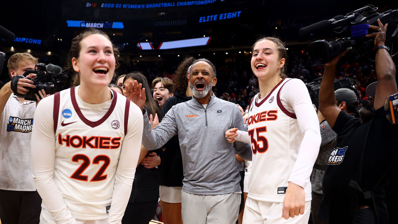 SEATTLE, WA - MARCH 27: Virginia Tech Hokies guard Cayla King #22 and guard Taylor Geiman #35 celebrate with head coach Kenny Brooks after defeating the Ohio State Buckeyes during the Elite Eight round of the 2023 NCAA Women's Basketball Tournament held at Climate Pledge Arena on March 27, 2023 in Seattle, Washington. Virginia Tech won 84-74.