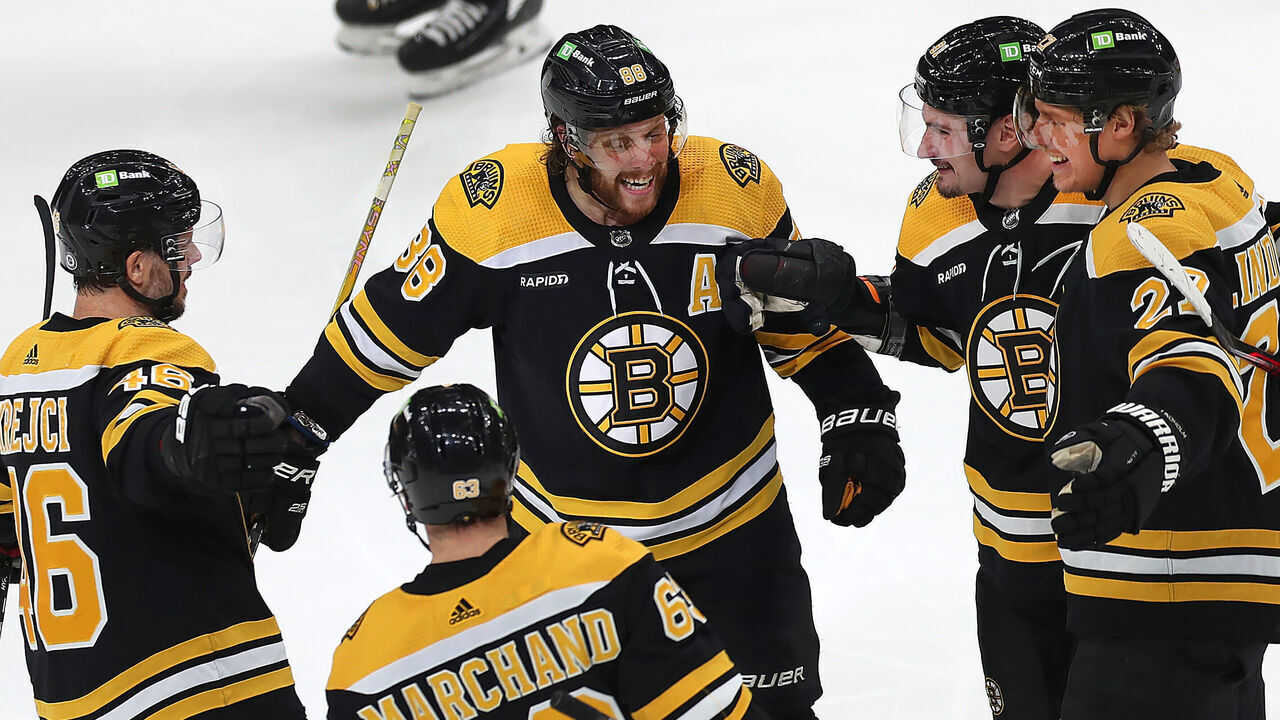 Boston, MA - March 2: From left to right, Boston Bruins David Krejci, Brad Marchand, David Pastrnak, Dmitry Orlov, and Hampus Lindholm gather up to celebrate a second period goal scored by Orlov. The Bruins beat the Buffalo Sabres, 7-1.