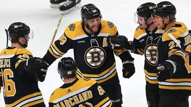Boston, MA - March 2: From left to right, Boston Bruins David Krejci, Brad Marchand, David Pastrnak, Dmitry Orlov, and Hampus Lindholm gather up to celebrate a second period goal scored by Orlov. The Bruins beat the Buffalo Sabres, 7-1.
