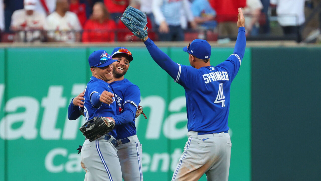 ST. LOUIS, MO - MARCH 30: George Springer #4 of the Toronto Blue Jays celebrates with teammates after winning the game against the St. Louis Cardinals at Busch Stadium on Thursday, March 30, 2023 in St. Louis, Missouri.