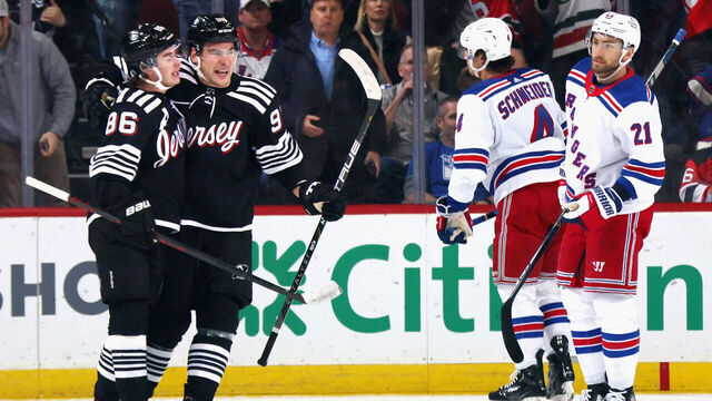 NEWARK, NEW JERSEY - MARCH 30: Timo Meier #96 of the New Jersey Devils (R) celebrates his first period powerplay goal against the New York Rangers and is joined by Jack Hughes #86 (L) at the Prudential Center on March 30, 2023 in Newark, New Jersey.