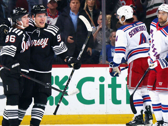 NEWARK, NEW JERSEY - MARCH 30: Timo Meier #96 of the New Jersey Devils (R) celebrates his first period powerplay goal against the New York Rangers and is joined by Jack Hughes #86 (L) at the Prudential Center on March 30, 2023 in Newark, New Jersey.