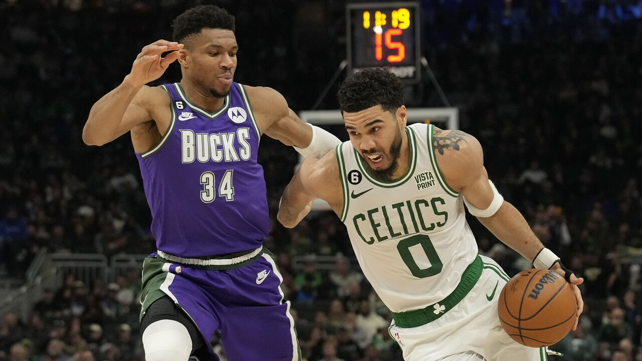 MILWAUKEE, WISCONSIN - MARCH 30: Jayson Tatum #0 of the Boston Celtics dribbles the ball against Giannis Antetokounmpo #34 of the Milwaukee Bucks in the second half at Fiserv Forum on March 30, 2023 in Milwaukee, Wisconsin.