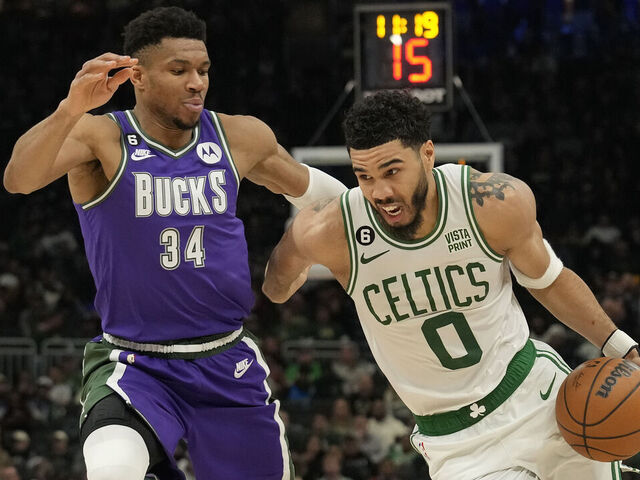 MILWAUKEE, WISCONSIN - MARCH 30: Jayson Tatum #0 of the Boston Celtics dribbles the ball against Giannis Antetokounmpo #34 of the Milwaukee Bucks in the second half at Fiserv Forum on March 30, 2023 in Milwaukee, Wisconsin.