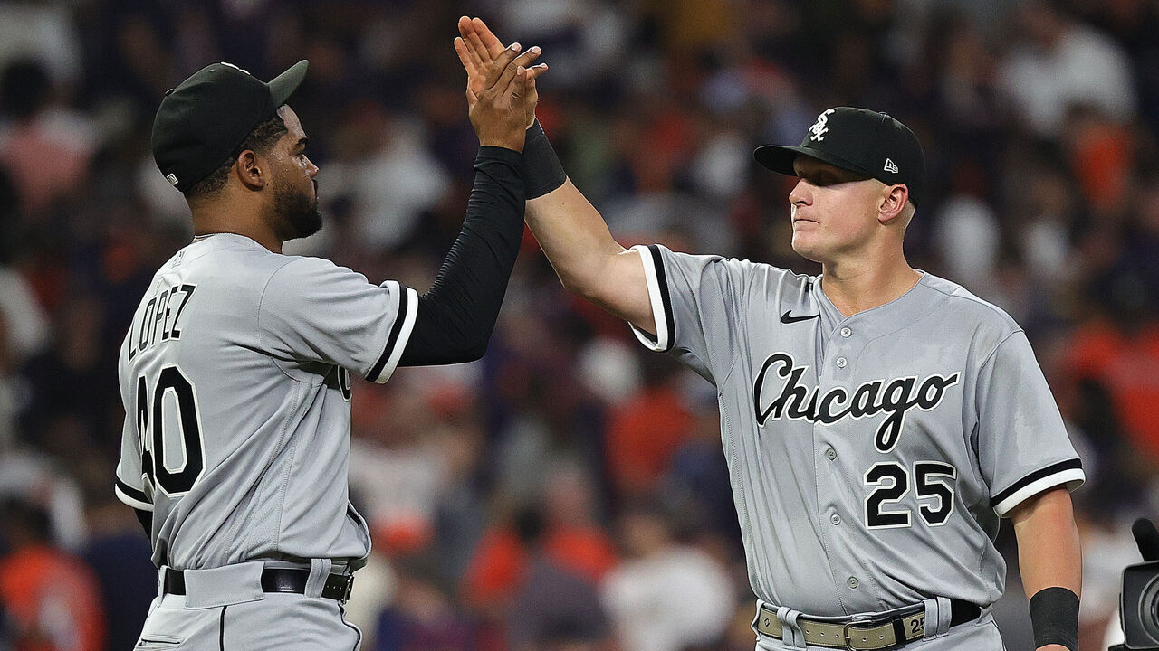 HOUSTON, TEXAS - MARCH 30: Andrew Vaughn #25 of the Chicago White Sox high fives Reynaldo Lopez #40 after defeating the Houston Astros on Opening Day at Minute Maid Park on March 30, 2023 in Houston, Texas.