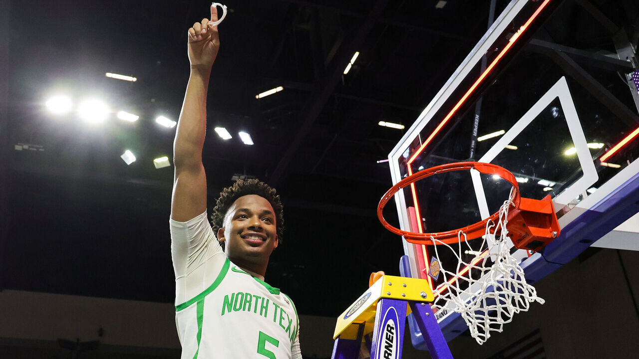 LAS VEGAS, NEVADA - MARCH 30: Tylor Perry #5 of the North Texas Mean Green, the Most Outstanding Player award recipient, poses after cutting a piece of a net down after the team's 68-61 victory over the UAB Blazers to win the championship game of the NIT basketball tournament at the Orleans Arena on March 30, 2023 in Las Vegas, Nevada.