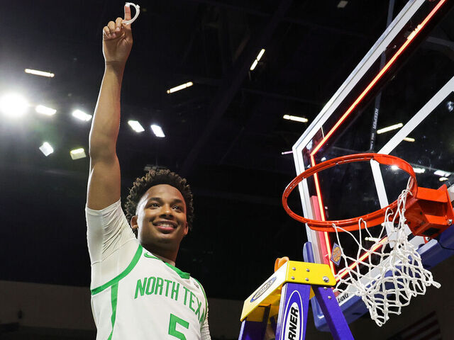 LAS VEGAS, NEVADA - MARCH 30: Tylor Perry #5 of the North Texas Mean Green, the Most Outstanding Player award recipient, poses after cutting a piece of a net down after the team's 68-61 victory over the UAB Blazers to win the championship game of the NIT basketball tournament at the Orleans Arena on March 30, 2023 in Las Vegas, Nevada.