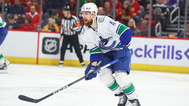 CHICAGO, IL - MARCH 26: Vancouver Canucks defenseman Filip Hronek (17) controls the puck during a game between the Vancouver Canucks and the Chicago Blackhawks on March 26, 2022 at the United Center in Chicago, IL.